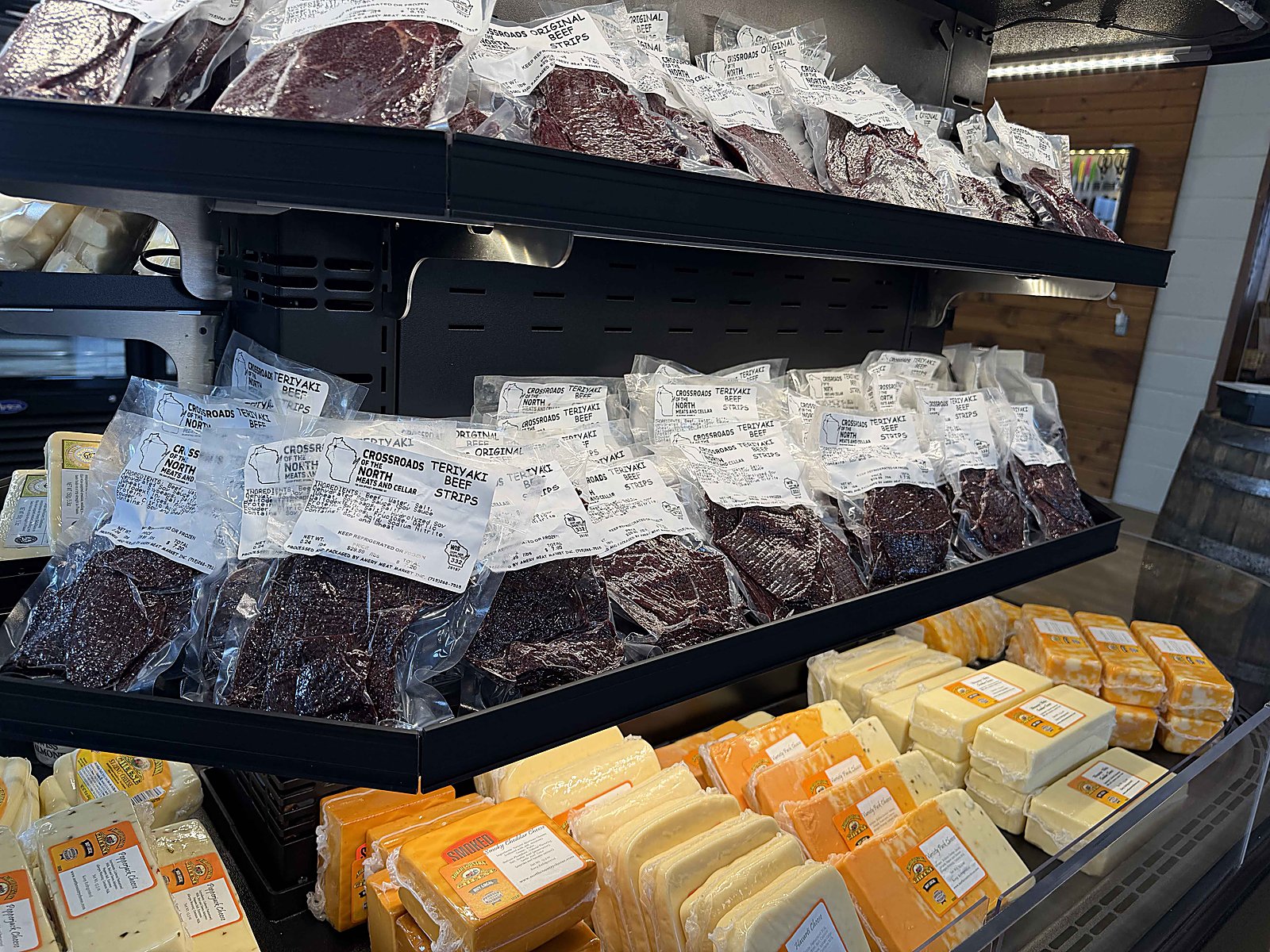 Crossroads Original and Teriyaki beef strips and jerky on the shelf above Wisconsin cheese