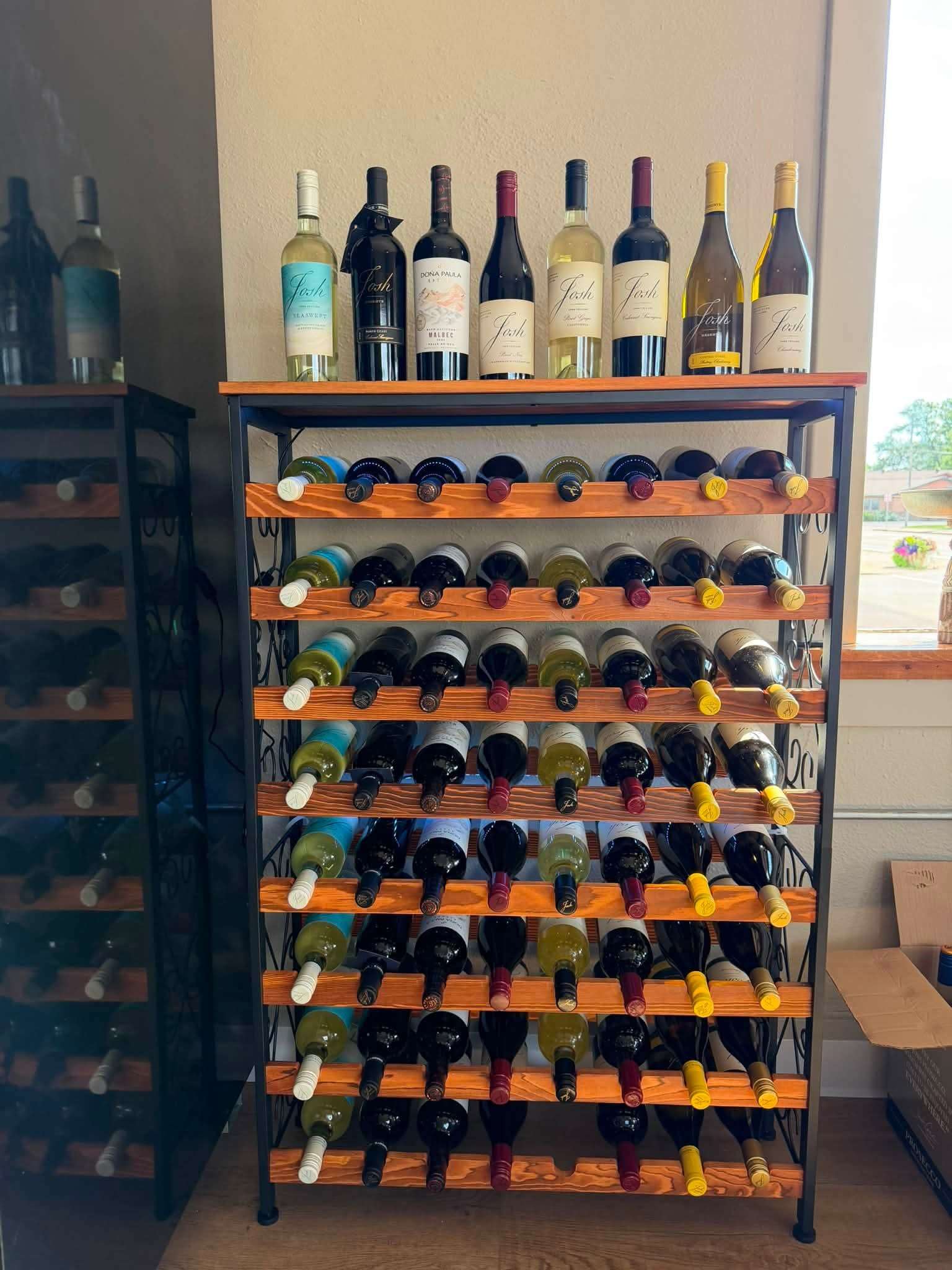 Wood and wrought-iron wine rack with curated bottle selection