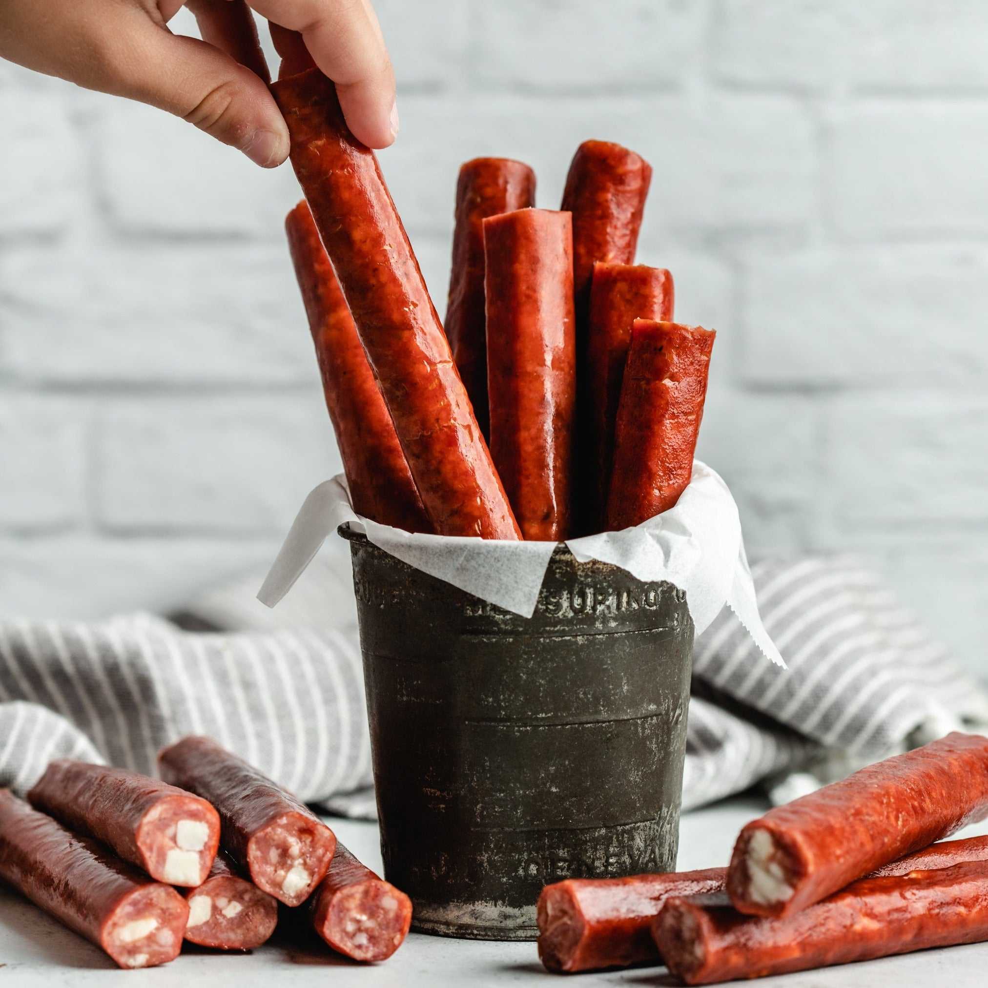 Smoked cheese-filled snack sticks in a vintage pail